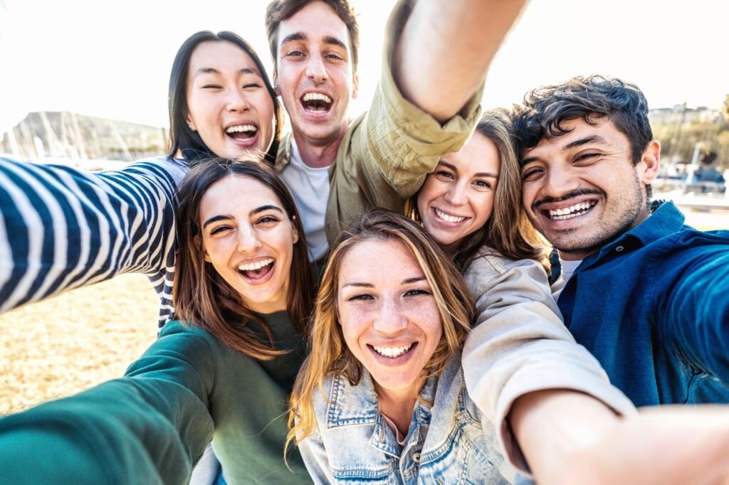 Multicultural group of friends taking selfie picture outside ArubaBuddiescom Multicultural group of friends taking selfie picture outside